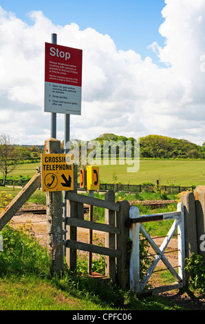 Rail crossing signs and telephone on the Bittern Line near Sheringham, Norfolk, England, United Kingdom. Stock Photo