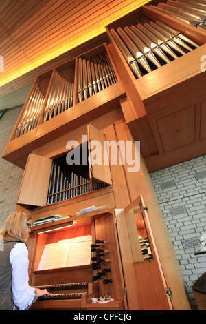 A woman playing pipe organ during an evangelical church service, Germany Stock Photo