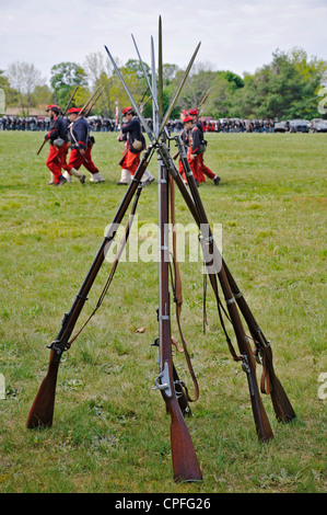 Rifles pyramid in front of  marching soldiers, Civil War reenactment, Bensalem, Pennsylvania, USA Stock Photo