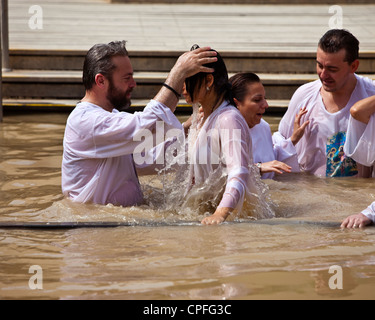 Russian Orthodox Christian Baptism, on the Israeli bank of the River Jordan, from Bethany Beyond The Jordan, Western Asia Stock Photo
