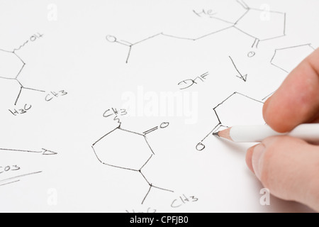 Researcher or teacher writing chemical formula on paper Stock Photo