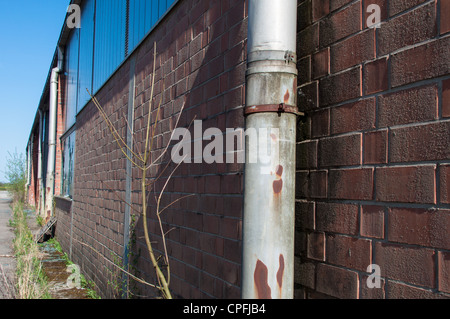 detail shot of an abandoned factory with broken windows Stock Photo