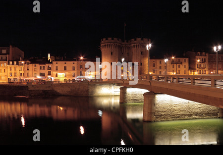 View over the River Meuse at night towards La Porte Chaussee in Verdun, Meuse, Lorraine, France. Stock Photo