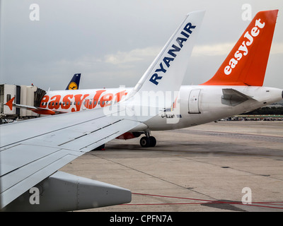 Ryanair and easyJet airplanes side by side on an airport runway Stock Photo