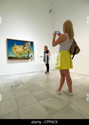 Visitors looking at Salvador Dali painting 'El Gran Masturbador' in the Reina Sofia modern art museum in Madrid, Spain Stock Photo