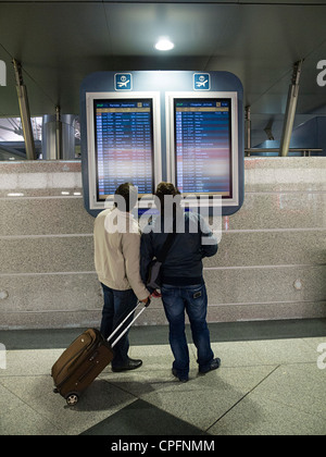 People looking at flight schedule board at Sá Carneiro airport in Porto, Portugal Stock Photo