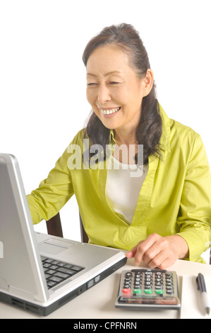 Senior woman using laptop Stock Photo