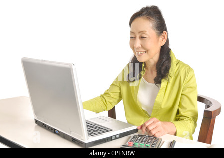 Senior woman using laptop Stock Photo