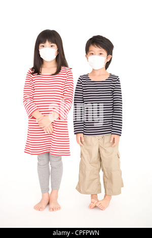 Boy and girl wearing mask Stock Photo