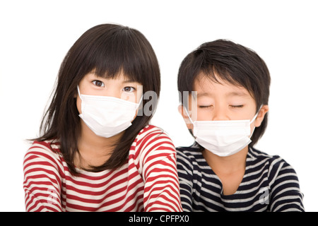 Boy and girl wearing mask Stock Photo