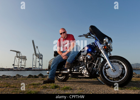 A Harley Davidson motorcyclist sitting on his bike Stock Photo