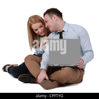 Young couple sitting together and working on a laptop Stock Photo