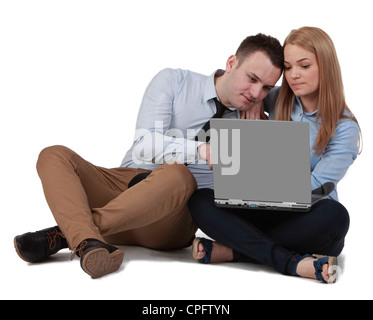 Young couple sitting together and working on a laptop Stock Photo