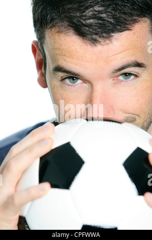 closeup of passionate soccer player with white and black balloon Stock Photo