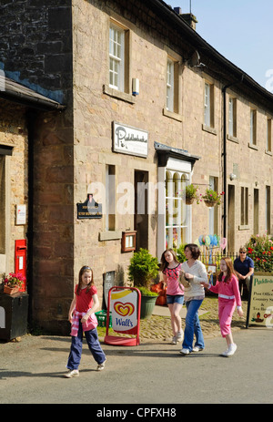 Family outside cafe at Dunsop Bridge in the Forest of Bowland Lancashire England, said to be the centre of Great Britain Stock Photo