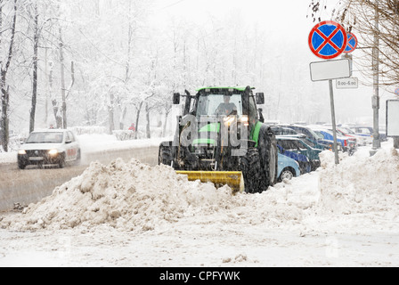snowplough works during heavy snow in city Stock Photo