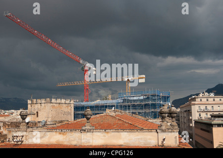 Construction cranes against stormy sky, Palermo, Sicily, Italy. Stock Photo