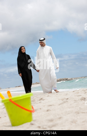 Young arab couple walking at the beach. Stock Photo