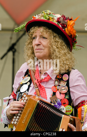 female Morris Dancer playing the accordion. Stock Photo