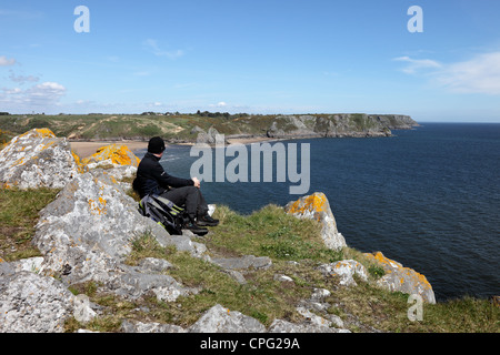 Walker Enjoying the View Over Three Cliffs Bay From Great Torr Penmaen Burrows Gower Wales UK Stock Photo