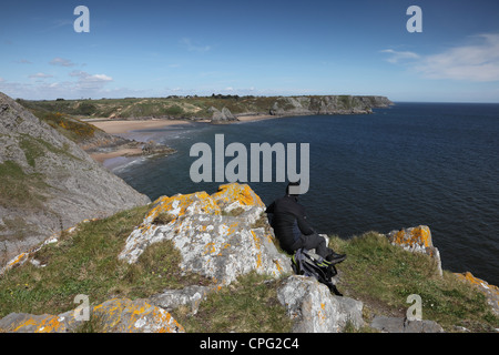 Walker Enjoying the View Over Three Cliffs Bay From Great Torr Penmaen Burrows Gower Wales UK Stock Photo