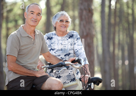 Senior couple on a bicycle Stock Photo