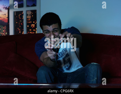 Young adult playing with Joy stick Stock Photo