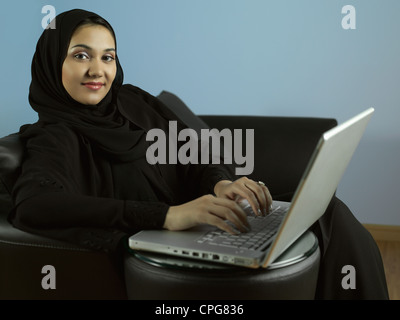 Arab lady working on laptop. Stock Photo