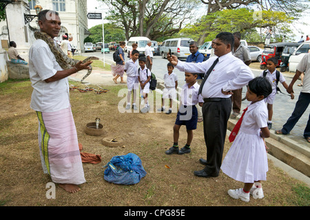 Sri Lankan audience watching snake charmer, Galle, Sri Lanka, Asia Stock Photo
