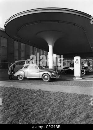 transport / transportation,car,petrol station,man filling up his DKW F 93 car of the Auto Union,Germany,1950s,Germany,50s,20th century,historic,historical,petrol pump,gas pump,petrol pumps,gas pumps,petrol station,gas station,petrol stations,gas stations,service station,service stations,autocar,automobile,motor vehicle,autocars,automobiles,motor vehicles,automobile,automobiles,petrol,gas,gasoline,gas-guzzling,fuel,fuels,fossil fuel,solid fuel,combustible,gaseous fuel,problem fuel,fuel,architecture,man,men,male,people,Additional-Rights-Clearences-Not Available Stock Photo