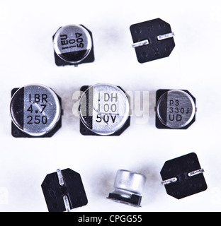 Various value aluminum capacitors used in SMT / SMD assembly in the electronics industry. Stock Photo
