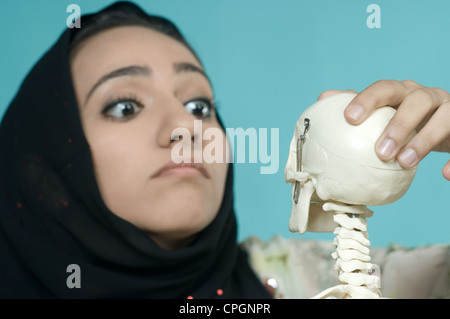 Woman holding human skeleton, close-up Stock Photo