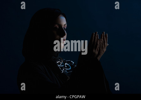 Young woman praying, close-up Stock Photo