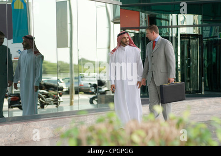 Businessmen walking on sidewalk Stock Photo