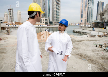 Businessmen in Dishdash at construction site with layouts Stock Photo