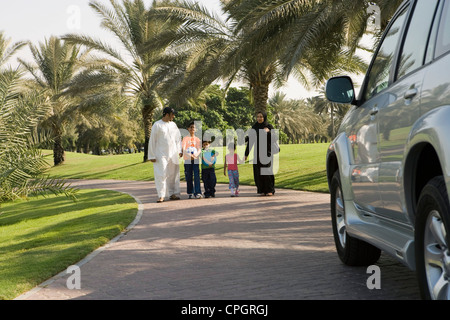 Parents with children walking at park Stock Photo