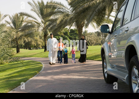 Parents with children walking at park Stock Photo
