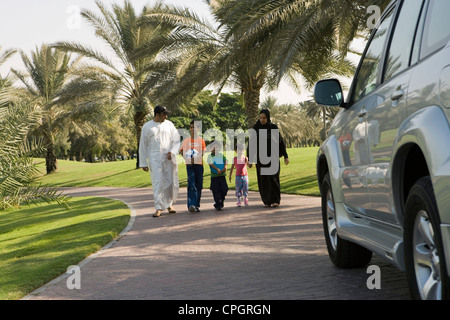 Parents with children walking at park Stock Photo