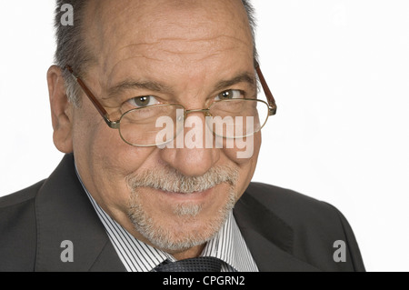 Mature man wearing glasses smiling, close-up Stock Photo