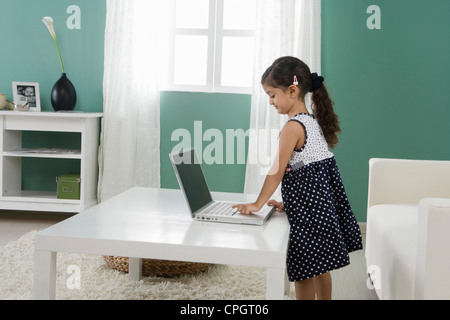 Girl (4-5 years old) using laptop at home Stock Photo