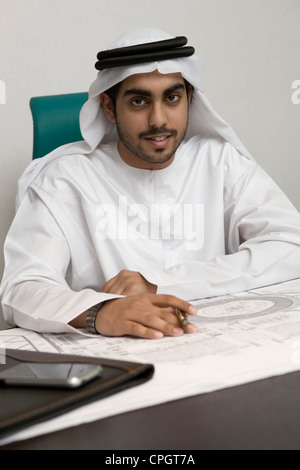 Arab businessman holding a pen, looking at the camera Stock Photo