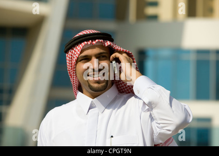 Arab businessman talking on Cellphone, standing Stock Photo