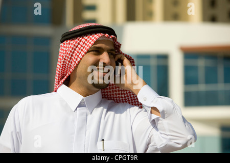 Arab businessman talking on Cellphone, standing Stock Photo