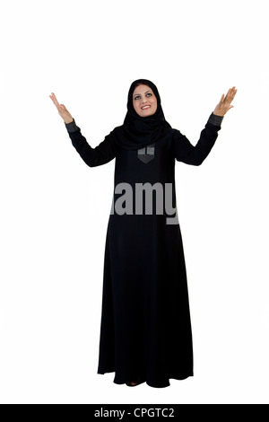 Arab woman with hands up, looking up Stock Photo