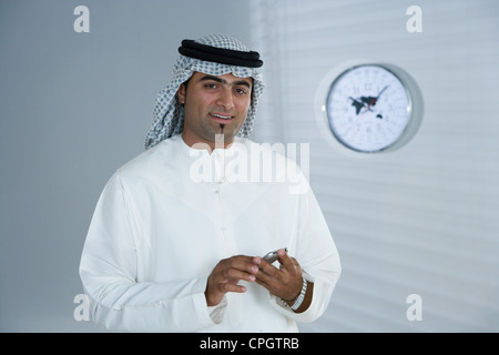 Arab man holding a cellphone Stock Photo