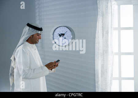 Arab man holding a cellphone Stock Photo
