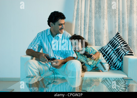 Father and son playing video games Stock Photo