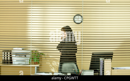 Arab businesswoman talking on phone in the office Stock Photo