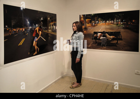 A young Israeli woman views a photograph by Eddie Gerald depicting Social Protests in Tel Aviv at a photography exhibition in Naggar school of Photography also called Musrara school in Musrara neighborhood West Jerusalem Israel