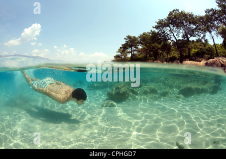 Split level, the man diving, Cleopatra island (Sedir Island), Aegean Sea, Turkey Stock Photo